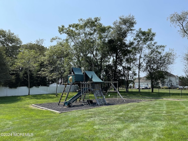 view of playground with a lawn