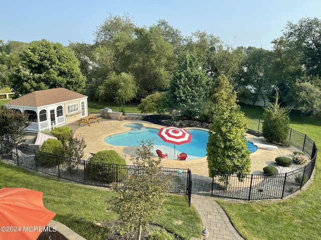 view of swimming pool featuring an outdoor structure, a yard, and a patio