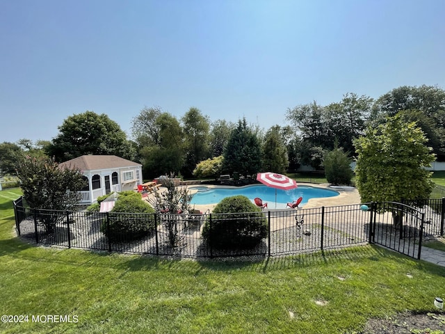 view of pool featuring a yard