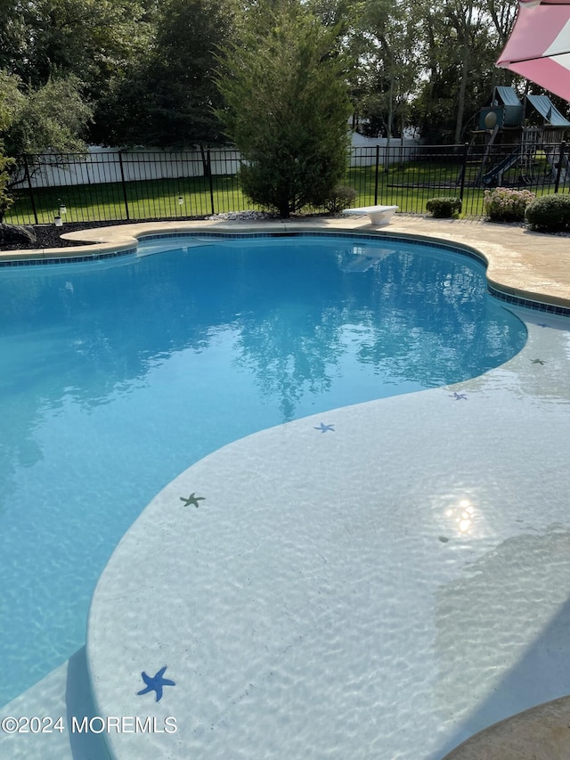 view of pool with a diving board