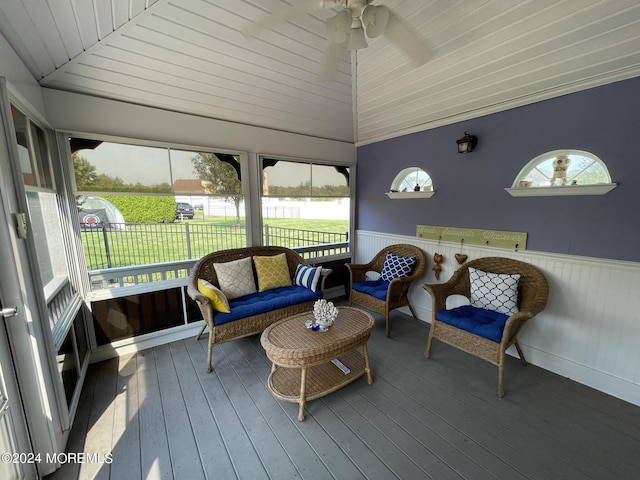 sunroom with ceiling fan and vaulted ceiling