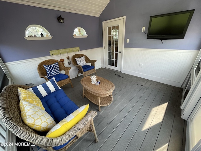 living room with dark hardwood / wood-style flooring and lofted ceiling