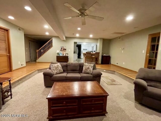 living room featuring beamed ceiling and ceiling fan