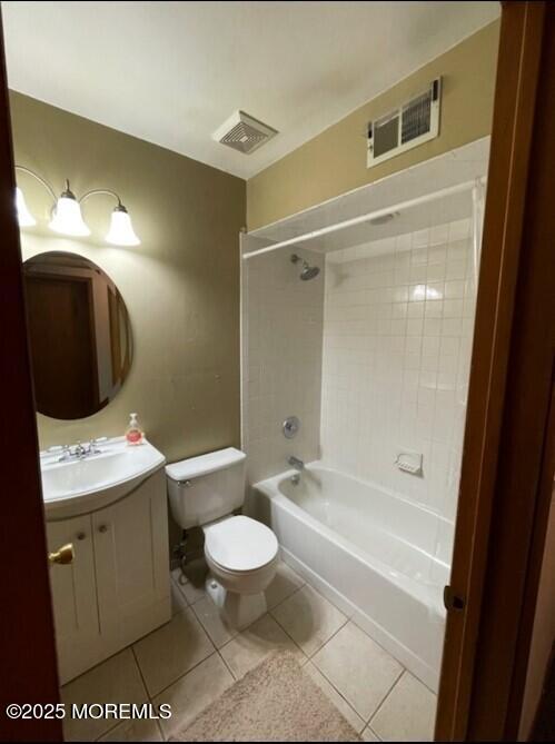 full bathroom featuring toilet, tile patterned flooring, vanity, and tiled shower / bath