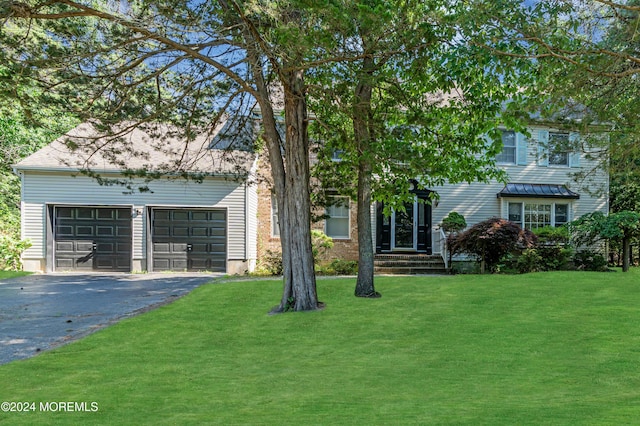 view of front of home with a garage and a front yard