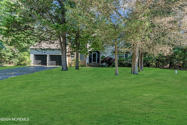 view of front facade with a garage and a front lawn