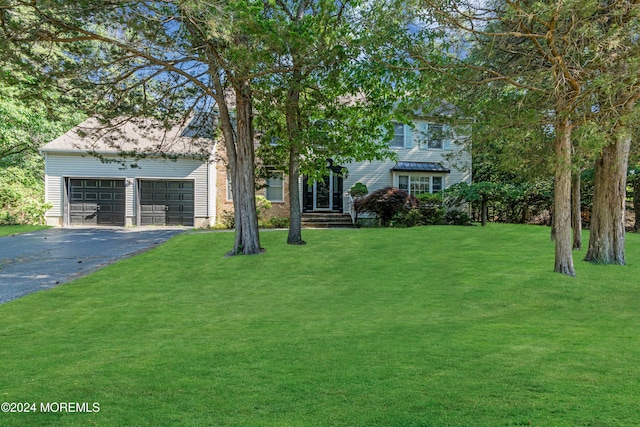 view of front of house with a front lawn and a garage