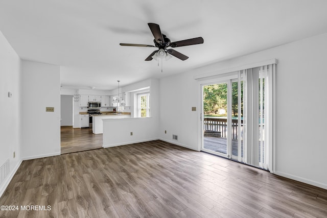 unfurnished living room featuring ceiling fan and light hardwood / wood-style flooring