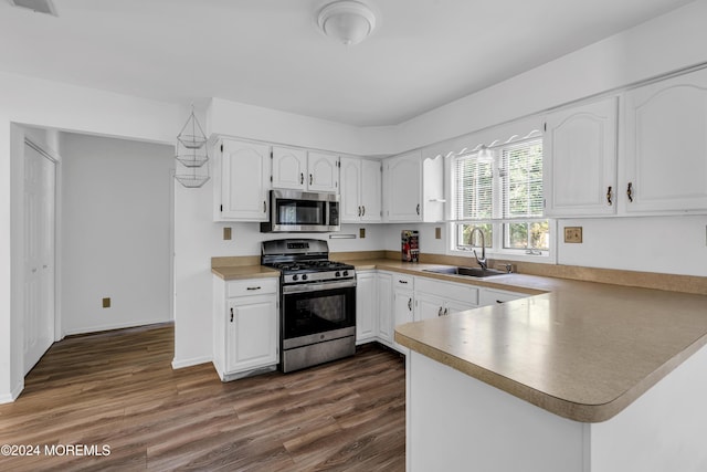 kitchen with sink, white cabinets, dark hardwood / wood-style floors, and appliances with stainless steel finishes