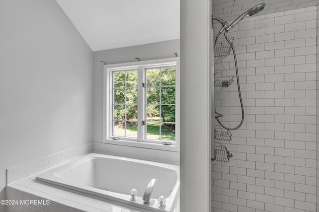 bathroom featuring independent shower and bath and vaulted ceiling