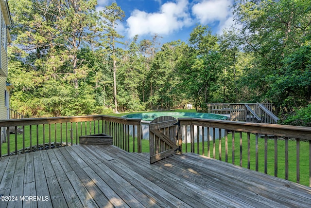 wooden deck with a lawn