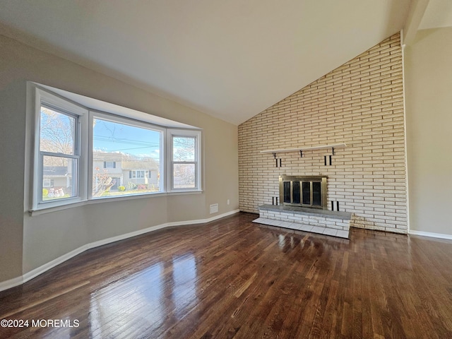 unfurnished living room featuring dark hardwood / wood-style flooring, a fireplace, and high vaulted ceiling