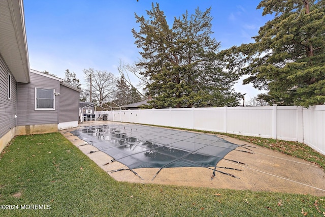 view of pool with a lawn and a patio area