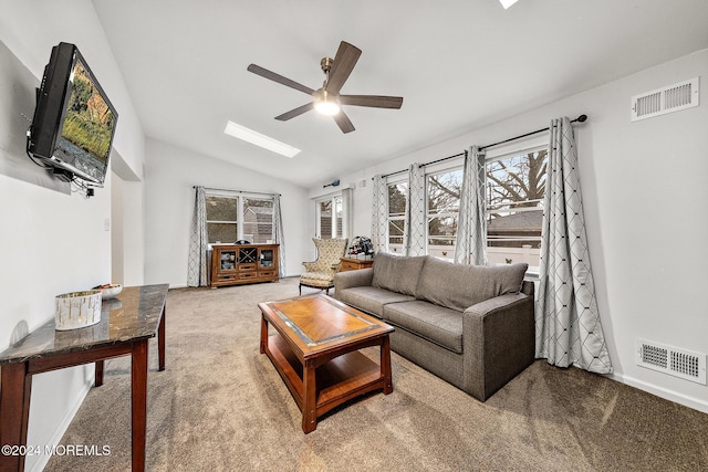 carpeted living room with ceiling fan and lofted ceiling