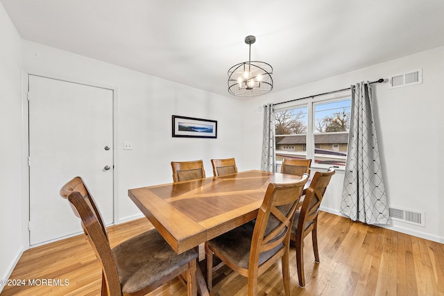 dining room featuring a chandelier and light hardwood / wood-style floors