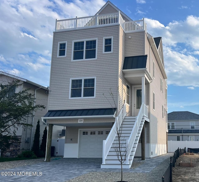 view of front of house featuring a balcony and a garage