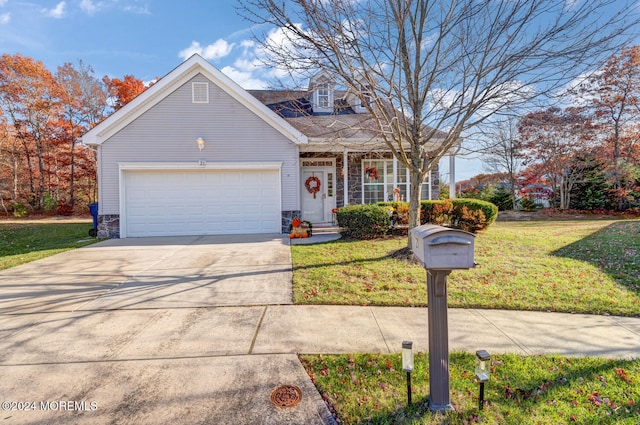 view of front of house with a front yard and a garage