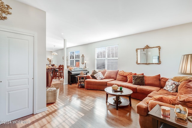 living room featuring hardwood / wood-style flooring and a notable chandelier