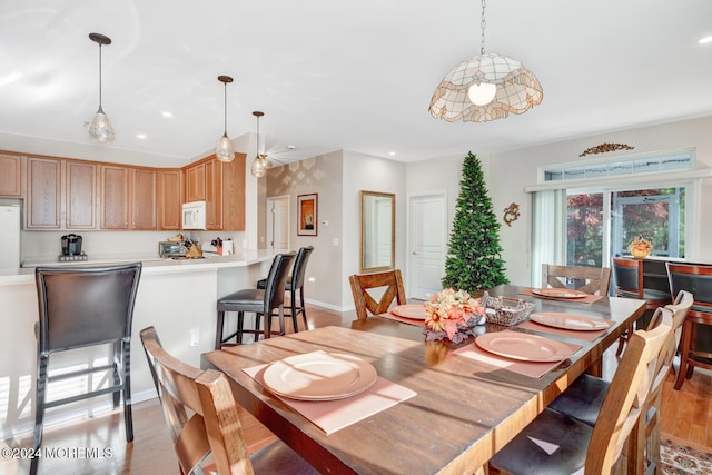 dining space with light wood-type flooring