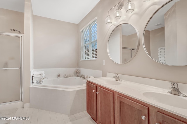 bathroom with tile patterned floors, vanity, and shower with separate bathtub