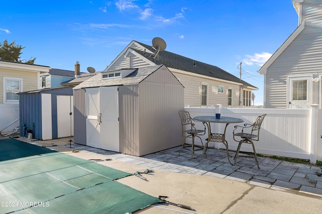 exterior space featuring a shed and a covered pool