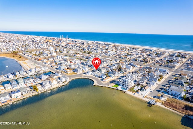 bird's eye view with a water view and a beach view