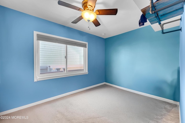 unfurnished room with ceiling fan and carpet floors