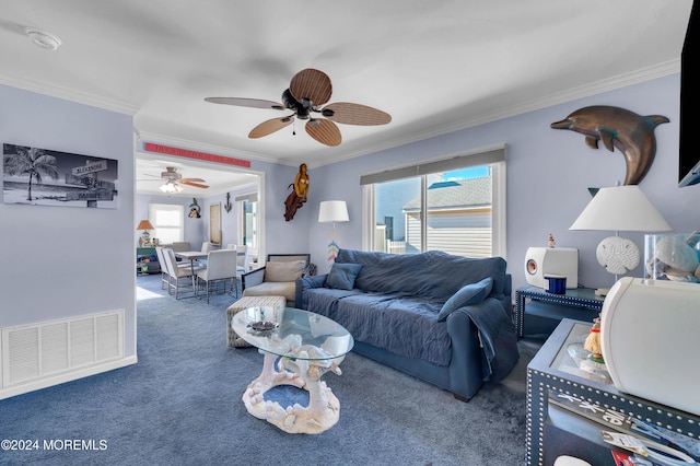 carpeted living room with ceiling fan and crown molding