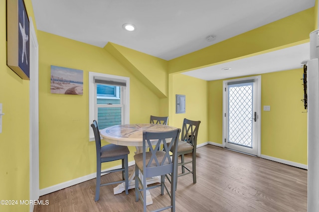 dining space featuring electric panel and light wood-type flooring