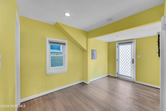 bonus room featuring light wood-type flooring and electric panel