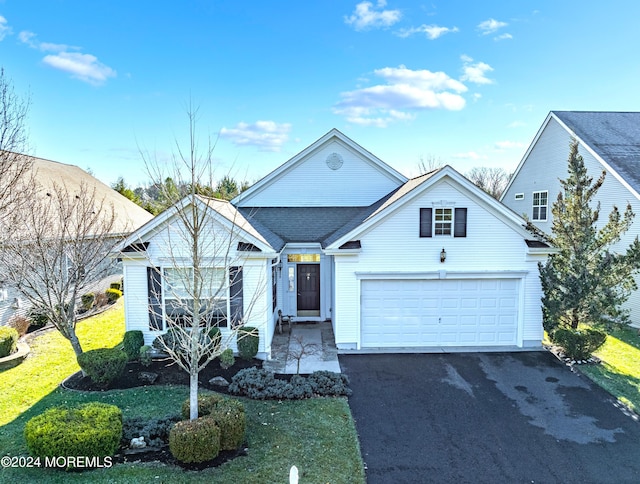 view of front facade featuring a front yard and a garage