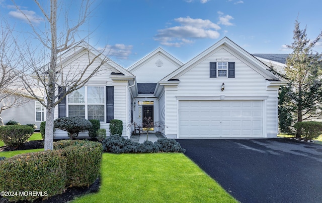 view of front of property with a garage and a front lawn