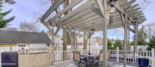 view of patio with an outdoor kitchen, a pergola, and grilling area