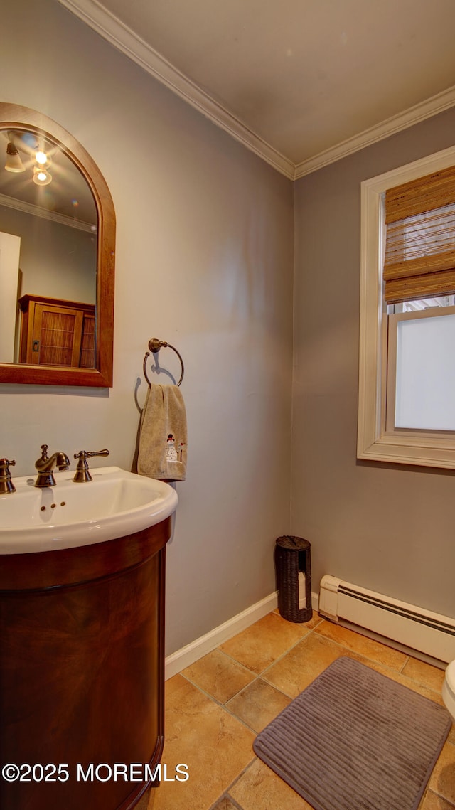 bathroom with baseboard heating, crown molding, and vanity