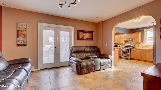 living room featuring french doors and track lighting