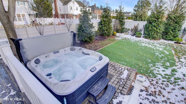 yard layered in snow featuring a hot tub