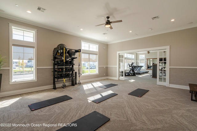 exercise room featuring light carpet, french doors, ceiling fan, and ornamental molding