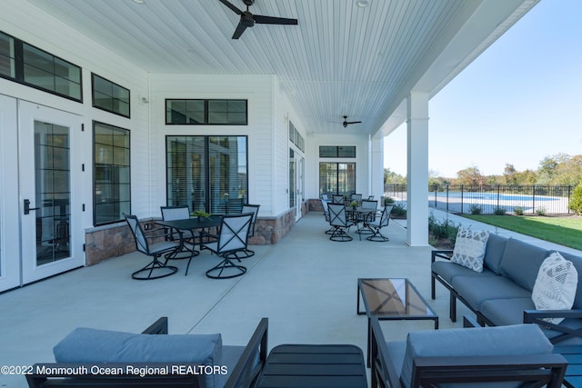 view of patio / terrace with an outdoor living space and ceiling fan