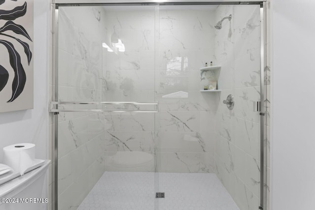 bathroom with a shower with door