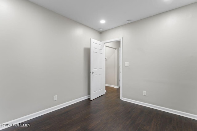 unfurnished room with dark hardwood / wood-style floors