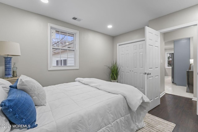 bedroom with hardwood / wood-style flooring and a closet