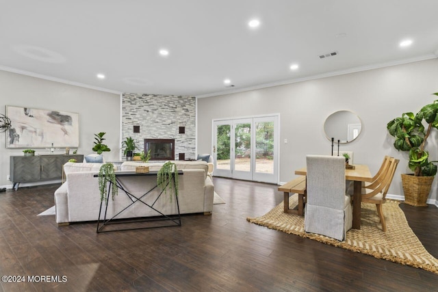 living room with a fireplace, crown molding, and dark wood-type flooring