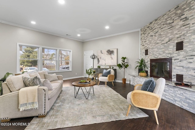 living room featuring wood-type flooring, a stone fireplace, and ornamental molding