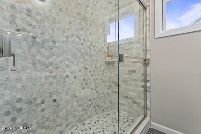 bathroom featuring a shower with door