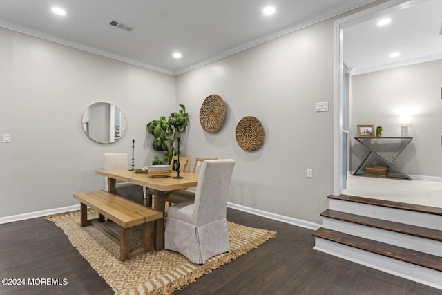 dining area featuring hardwood / wood-style flooring and crown molding