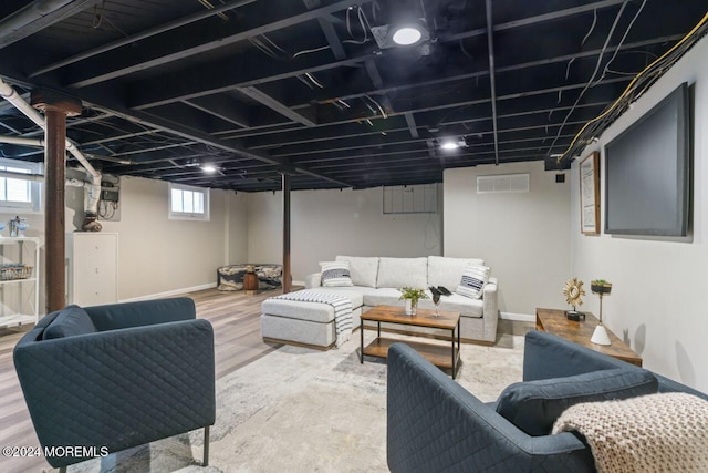 living room featuring wood-type flooring and a wealth of natural light