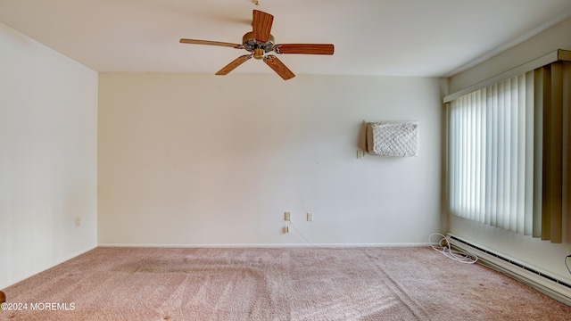 carpeted spare room with ceiling fan and a baseboard heating unit