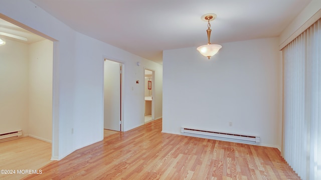 spare room with light hardwood / wood-style flooring and a baseboard heating unit