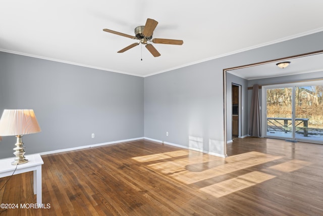 empty room with dark hardwood / wood-style flooring, ornamental molding, and ceiling fan