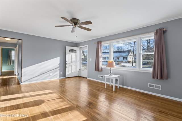 spare room featuring ceiling fan, hardwood / wood-style floors, and ornamental molding